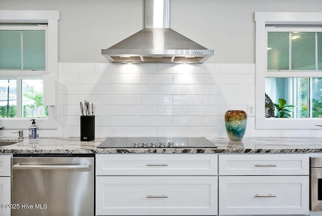 311 Lennox Pl, Wilmington, NC 28412 - kitchen with wall chimney exhaust hood, stainless steel dishwasher, black electric cooktop, white cabinets, and light stone counters