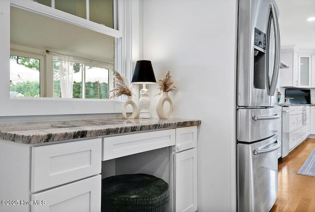 311 Lennox Pl, Wilmington, NC 28412 - kitchen view of stainless steel fridge with ice dispenser, white cabinetry, light wood-type flooring, stone counters, and glass insert cabinets