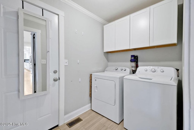311 Lennox Pl, Wilmington, NC 28412 - laundry area with cabinet space, washer and dryer, ornamental molding, and light wood-style flooring