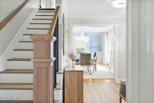 311 Lennox Pl, Wilmington, NC 28412 - staircase featuring wood finished floors, a chandelier, and ornamental molding
