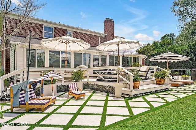 311 Lennox Pl, Wilmington, NC 28412 - back of property with a chimney, a sunroom, a deck, and a patio
