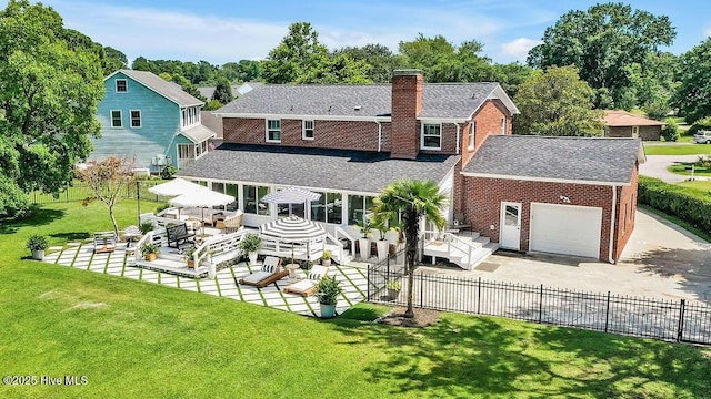 311 Lennox Pl, Wilmington, NC 28412 - back of house featuring roof with shingles, brick siding, driveway, a garage, and a chimney