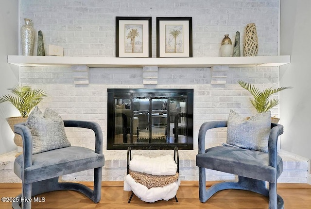 311 Lennox Pl, Wilmington, NC 28412 - sitting room with a brick fireplace and wood finished floors