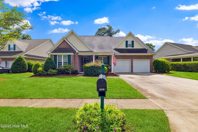 258 Morning View Way, Leland, NC 28451 - view of front of property featuring brick siding, concrete driveway, a front lawn, a garage, and roof with shingles