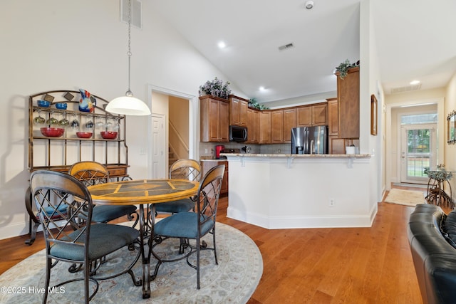 258 Morning View Way, Leland, NC 28451 - dining space featuring stairs, light wood-type flooring, recessed lighting, and high vaulted ceiling