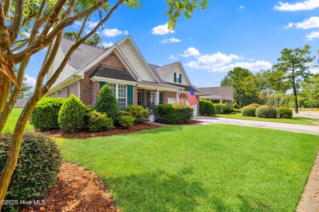258 Morning View Way, Leland, NC 28451 - view of front facade with driveway, brick siding, a front yard, and a shingled roof