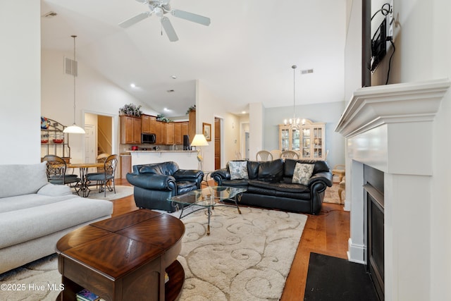 258 Morning View Way, Leland, NC 28451 - living area with light wood finished floors, a chandelier, ceiling fan, high vaulted ceiling, and recessed lighting