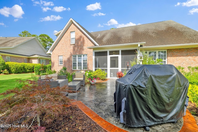 258 Morning View Way, Leland, NC 28451 - rear view of house with a sunroom, brick siding, a patio area, an outdoor hangout area, and a lawn