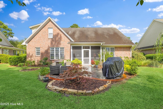 258 Morning View Way, Leland, NC 28451 - rear view of house with brick siding, a patio area, a sunroom, and a yard