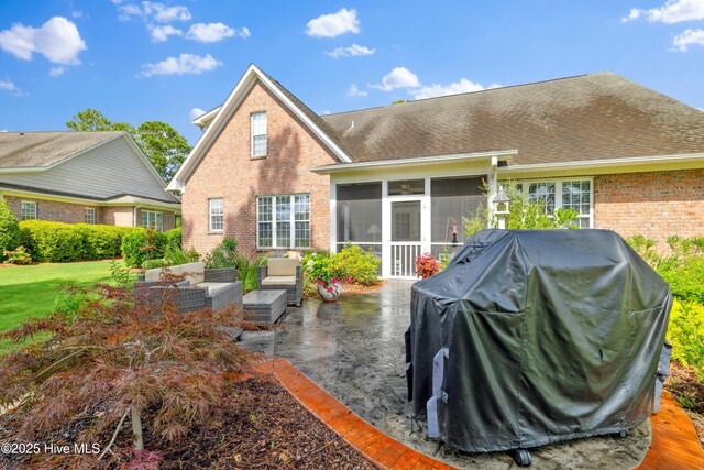 258 Morning View Way, Leland, NC 28451 - rear view of house with a sunroom, brick siding, a patio area, an outdoor hangout area, and a lawn