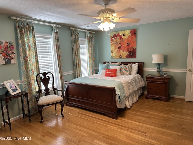 2270 Bella Coola Rd, Lake Waccamaw, NC 28450 - bedroom with light wood finished floors, a textured ceiling, and a ceiling fan