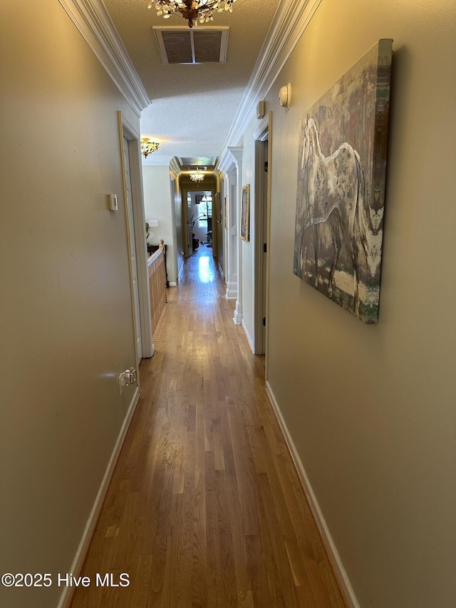 2270 Bella Coola Rd, Lake Waccamaw, NC 28450 - hallway featuring ornamental molding and wood finished floors