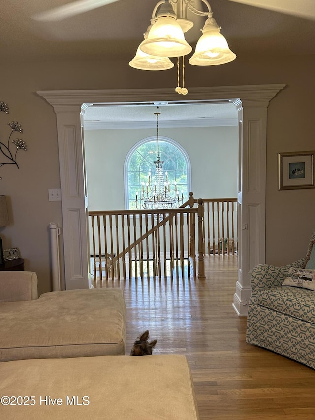 2270 Bella Coola Rd, Lake Waccamaw, NC 28450 - corridor featuring a chandelier, wood finished floors, and an upstairs landing
