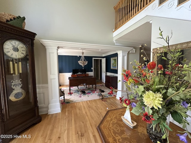 2270 Bella Coola Rd, Lake Waccamaw, NC 28450 - entrance foyer with wood finished floors, a wainscoted wall, ornate columns, and a towering ceiling