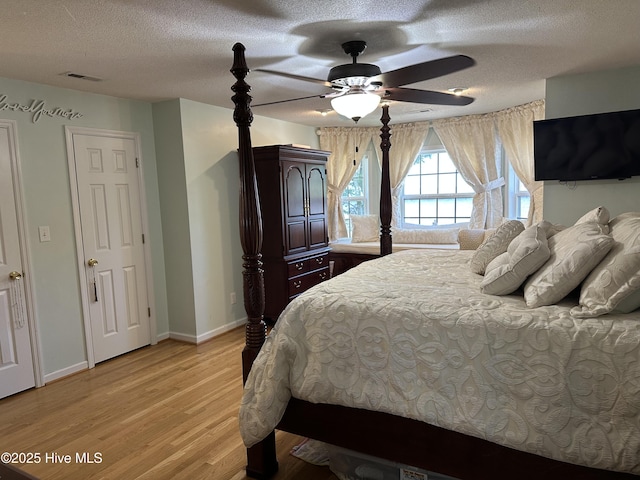 2270 Bella Coola Rd, Lake Waccamaw, NC 28450 - bedroom featuring light wood-type flooring, a textured ceiling, and ceiling fan