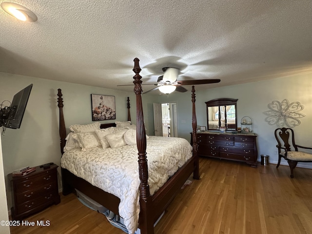 2270 Bella Coola Rd, Lake Waccamaw, NC 28450 - bedroom featuring wood finished floors, a textured ceiling, and ceiling fan