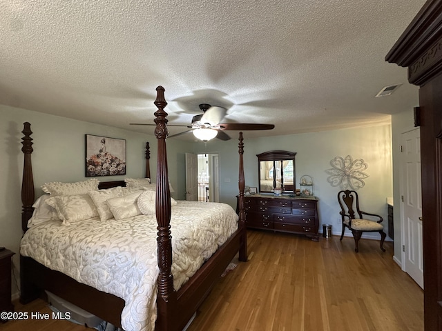 2270 Bella Coola Rd, Lake Waccamaw, NC 28450 - bedroom featuring wood finished floors, a textured ceiling, and ceiling fan