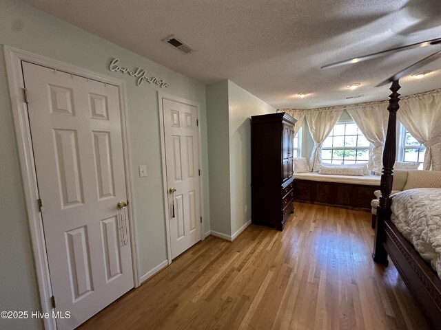 2270 Bella Coola Rd, Lake Waccamaw, NC 28450 - bedroom featuring light wood finished floors and a textured ceiling
