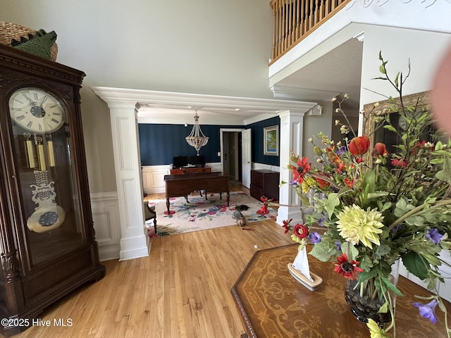 2270 Bella Coola Rd, Lake Waccamaw, NC 28450 - foyer entrance with decorative columns, wood finished floors, a wainscoted wall, and a high ceiling