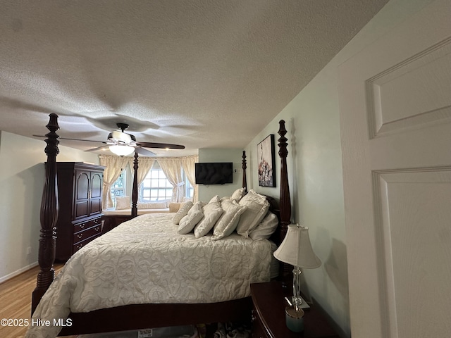 2270 Bella Coola Rd, Lake Waccamaw, NC 28450 - bedroom with a textured ceiling, wood finished floors, and ceiling fan