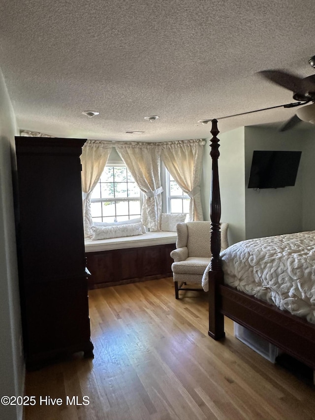 2270 Bella Coola Rd, Lake Waccamaw, NC 28450 - bedroom featuring wood finished floors and a textured ceiling