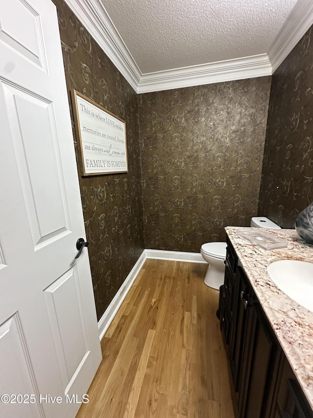 2270 Bella Coola Rd, Lake Waccamaw, NC 28450 - bathroom featuring wood finished floors, vanity, a textured ceiling, ornamental molding, and wallpapered walls