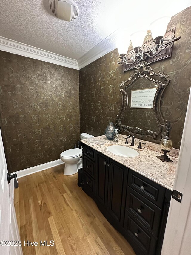 2270 Bella Coola Rd, Lake Waccamaw, NC 28450 - half bathroom with vanity, wood finished floors, crown molding, and a textured ceiling