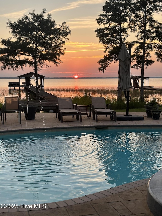 2270 Bella Coola Rd, Lake Waccamaw, NC 28450 - swimming pool featuring a water view and a patio