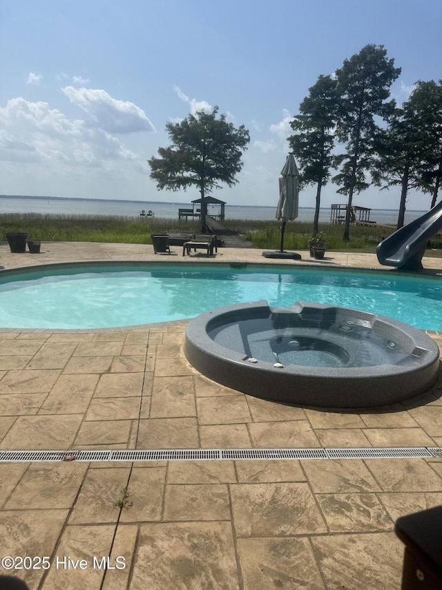 2270 Bella Coola Rd, Lake Waccamaw, NC 28450 - view of pool featuring a water slide, a pool with connected hot tub, and a patio area