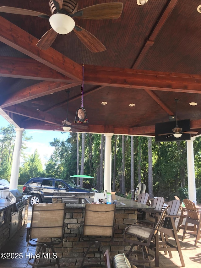 2270 Bella Coola Rd, Lake Waccamaw, NC 28450 - view of patio with a ceiling fan, area for grilling, and view of wooded area