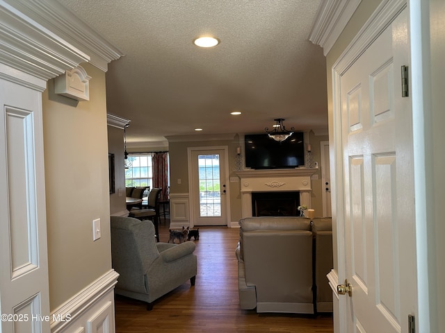 2270 Bella Coola Rd, Lake Waccamaw, NC 28450 - living room with dark wood-type flooring, a fireplace, ornamental molding, recessed lighting, and a textured ceiling