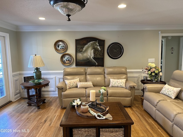 2270 Bella Coola Rd, Lake Waccamaw, NC 28450 - living area featuring light wood-type flooring, crown molding, wainscoting, recessed lighting, and a decorative wall