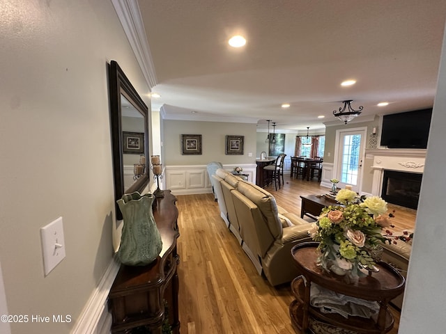 2270 Bella Coola Rd, Lake Waccamaw, NC 28450 - living area featuring crown molding, recessed lighting, light wood finished floors, wainscoting, and a fireplace