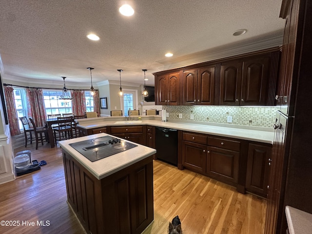 2270 Bella Coola Rd, Lake Waccamaw, NC 28450 - kitchen featuring black appliances, crown molding, a peninsula, dark brown cabinets, and light countertops
