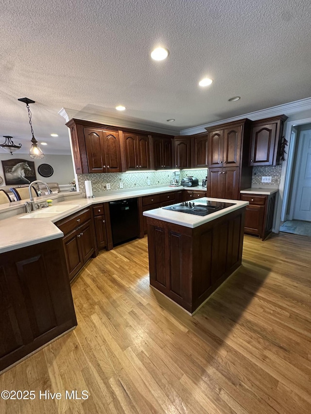 2270 Bella Coola Rd, Lake Waccamaw, NC 28450 - kitchen featuring black appliances, light countertops, a textured ceiling, dark brown cabinetry, and backsplash