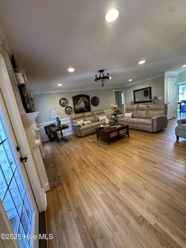 2270 Bella Coola Rd, Lake Waccamaw, NC 28450 - living area featuring light wood-style flooring, crown molding, recessed lighting, and a textured ceiling