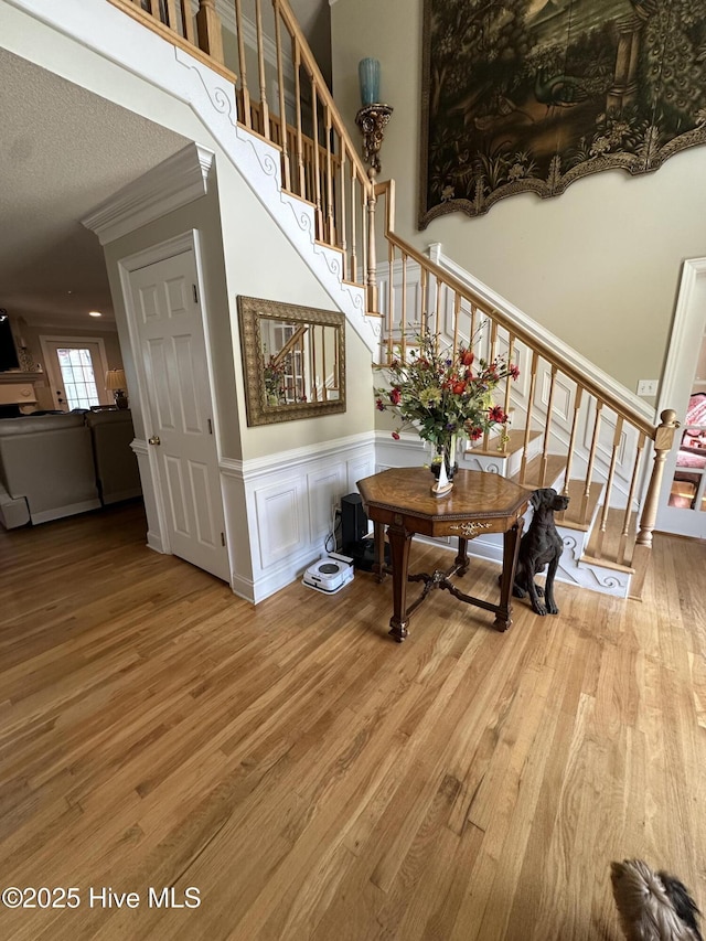2270 Bella Coola Rd, Lake Waccamaw, NC 28450 - staircase featuring wood finished floors, a wainscoted wall, and a decorative wall