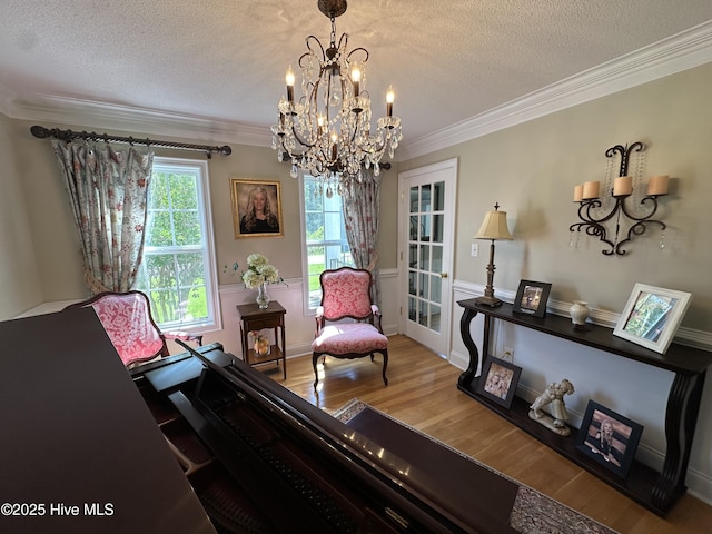 2270 Bella Coola Rd, Lake Waccamaw, NC 28450 - sitting room with a chandelier, wood finished floors, crown molding, and a textured ceiling