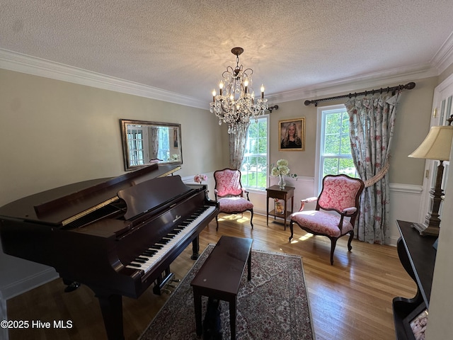 2270 Bella Coola Rd, Lake Waccamaw, NC 28450 - sitting room featuring crown molding, light wood-style floors, a textured ceiling, and a chandelier