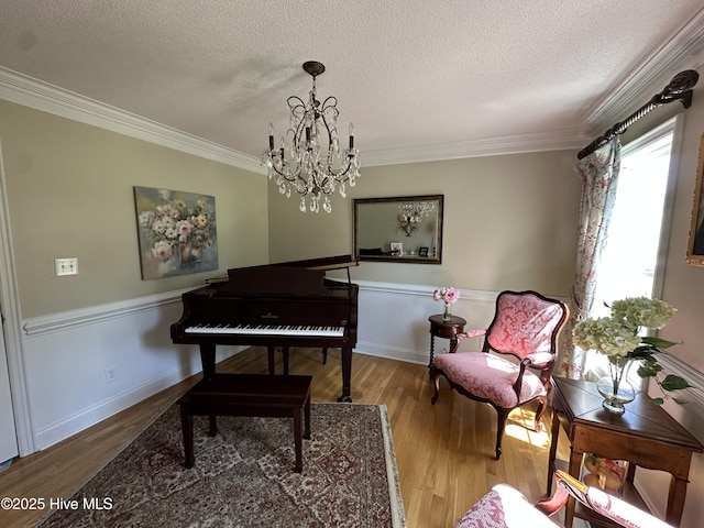 2270 Bella Coola Rd, Lake Waccamaw, NC 28450 - living area featuring a textured ceiling, crown molding, a chandelier, and wood finished floors