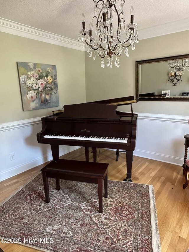 2270 Bella Coola Rd, Lake Waccamaw, NC 28450 - living area featuring crown molding, a textured ceiling, wood finished floors, and a chandelier