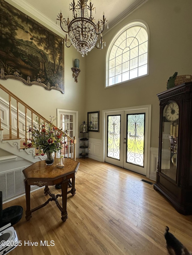 2270 Bella Coola Rd, Lake Waccamaw, NC 28450 - foyer entrance featuring a high ceiling, french doors, wood finished floors, stairway, and a chandelier