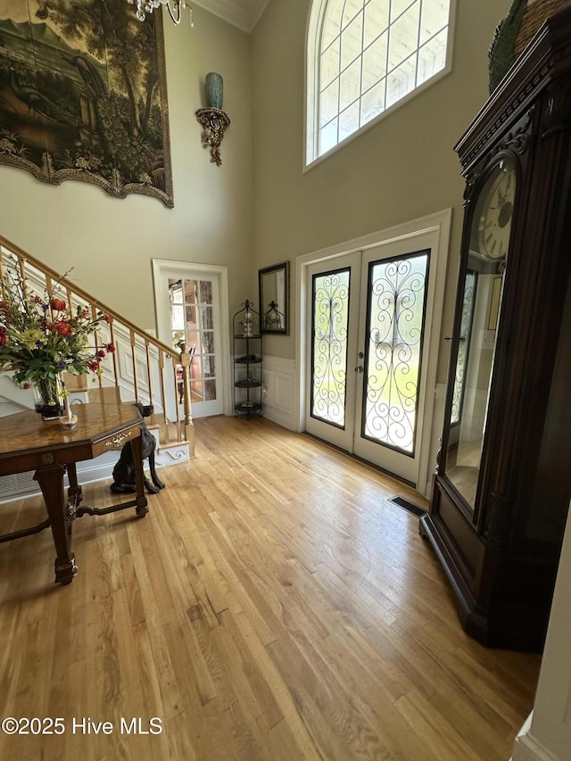 2270 Bella Coola Rd, Lake Waccamaw, NC 28450 - foyer with french doors, a towering ceiling, healthy amount of natural light, stairway, and light wood finished floors