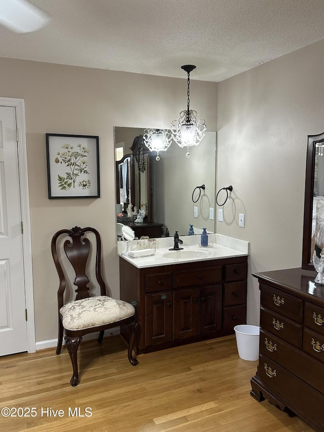 2270 Bella Coola Rd, Lake Waccamaw, NC 28450 - bathroom featuring wood finished floors, vanity, a chandelier, and a textured ceiling