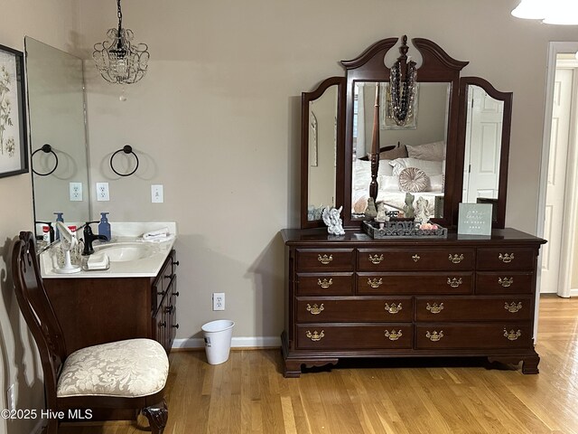 2270 Bella Coola Rd, Lake Waccamaw, NC 28450 - bathroom featuring wood finished floors, vanity, and a chandelier