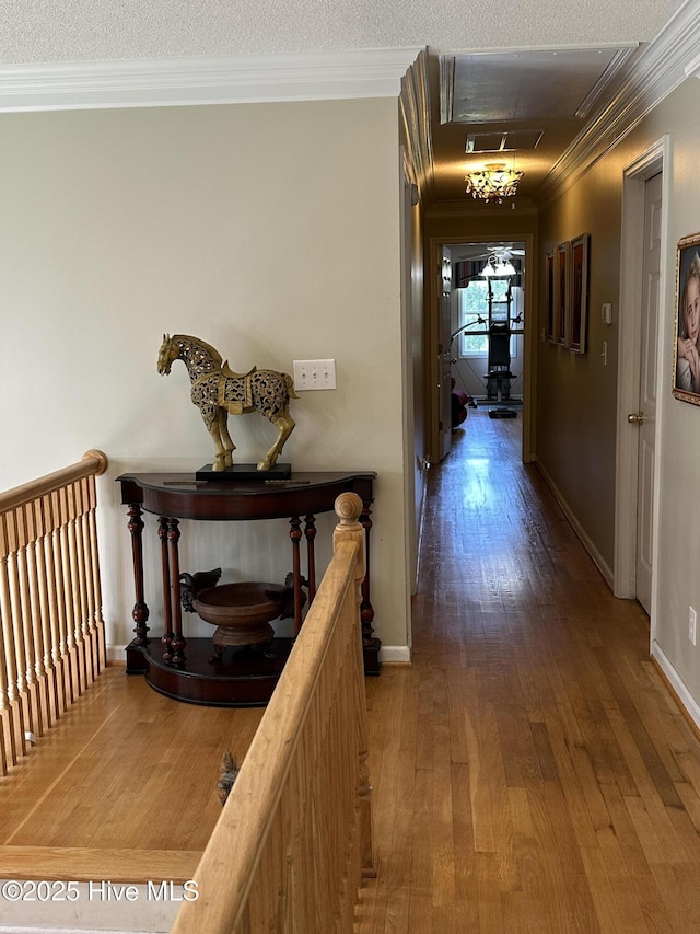 2270 Bella Coola Rd, Lake Waccamaw, NC 28450 - hall with ornamental molding, hardwood / wood-style flooring, an upstairs landing, and a textured ceiling