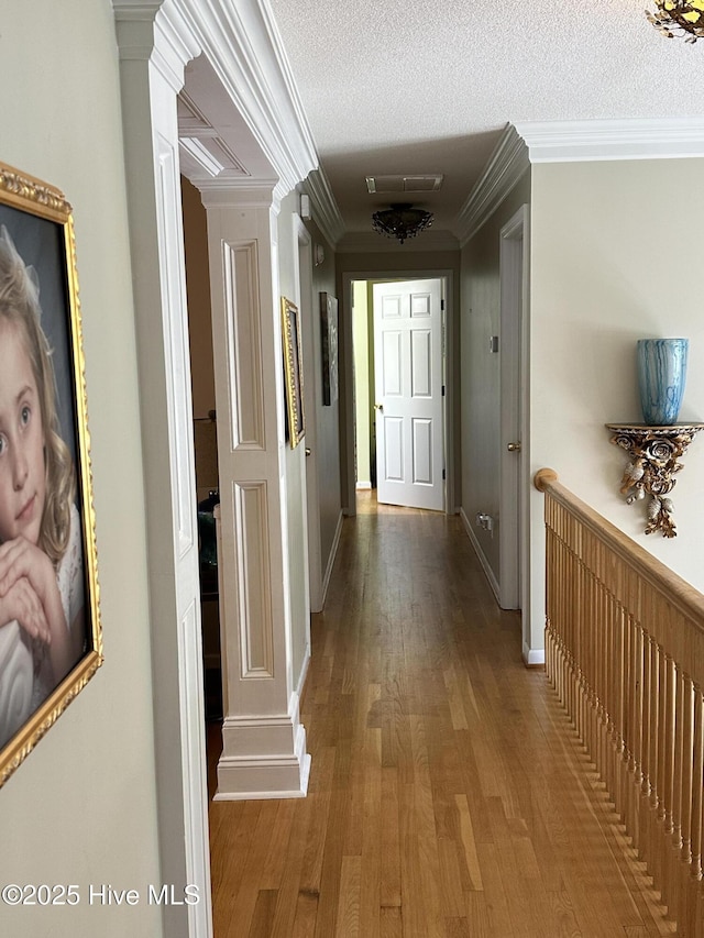 2270 Bella Coola Rd, Lake Waccamaw, NC 28450 - hall featuring ornate columns, wood finished floors, ornamental molding, and a textured ceiling