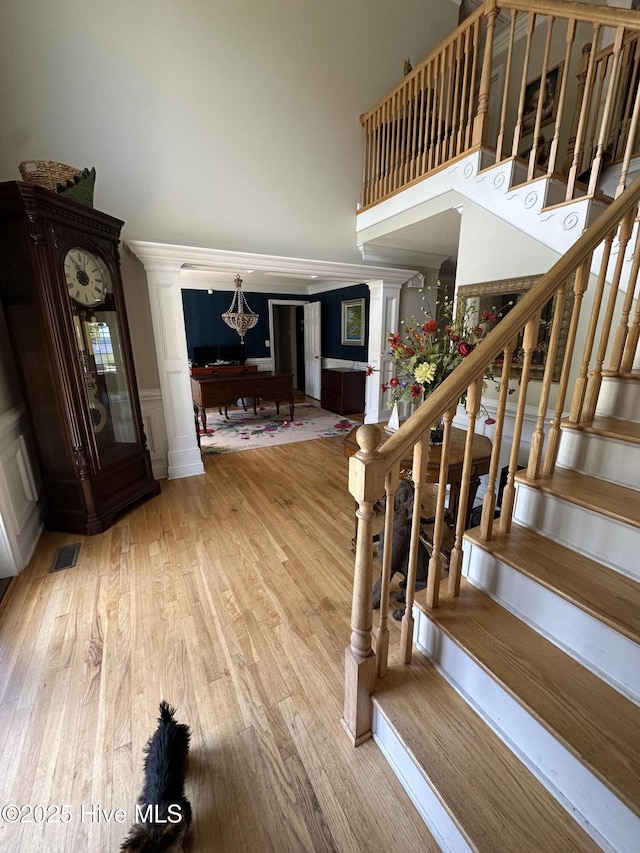 2270 Bella Coola Rd, Lake Waccamaw, NC 28450 - staircase featuring a high ceiling, wood finished floors, a wainscoted wall, and pool table