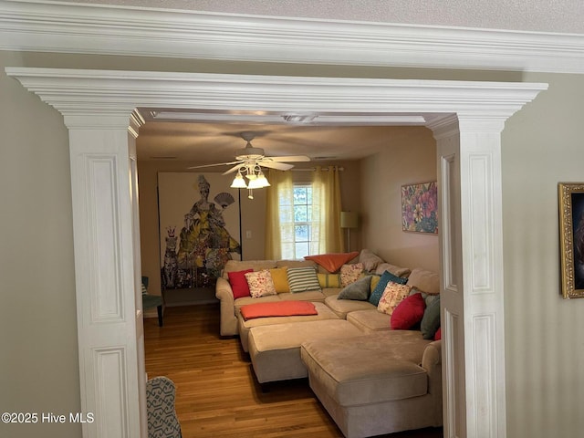 2270 Bella Coola Rd, Lake Waccamaw, NC 28450 - living area featuring decorative columns, wood finished floors, a ceiling fan, and crown molding