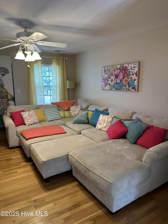 2270 Bella Coola Rd, Lake Waccamaw, NC 28450 - living room with wood finished floors, ceiling fan, and a textured ceiling